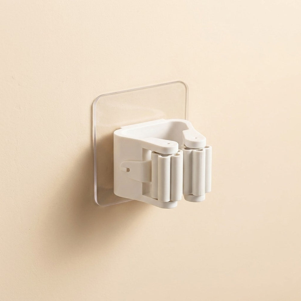 White shower head holder attached to a beige wall