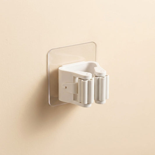 White shower head holder attached to a beige wall